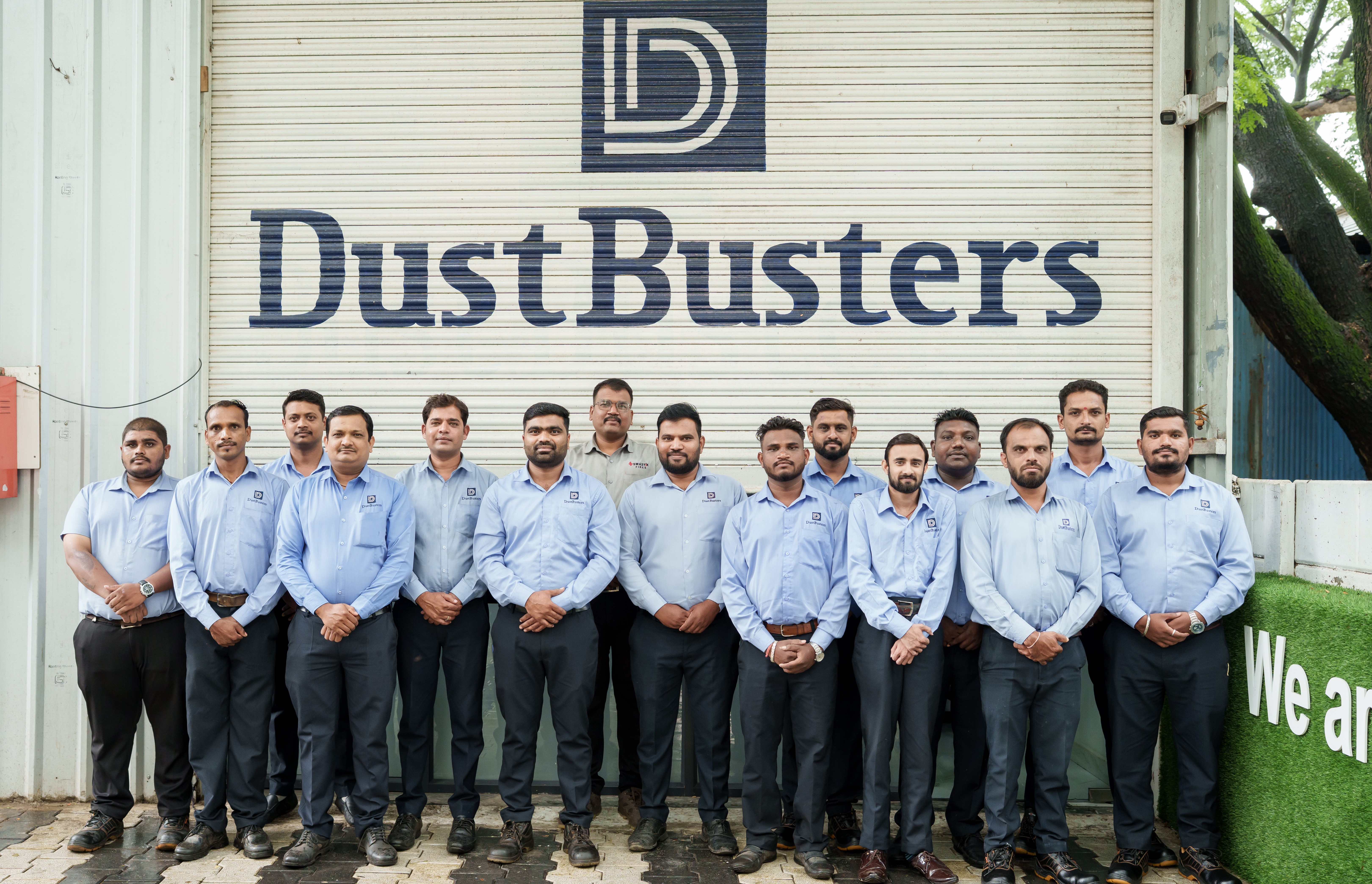 DustBusters team with facility equipment